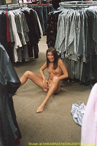 Spread-legged and naked in a busy shop