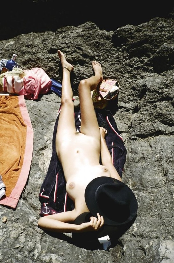 Nude sunbather with a hat